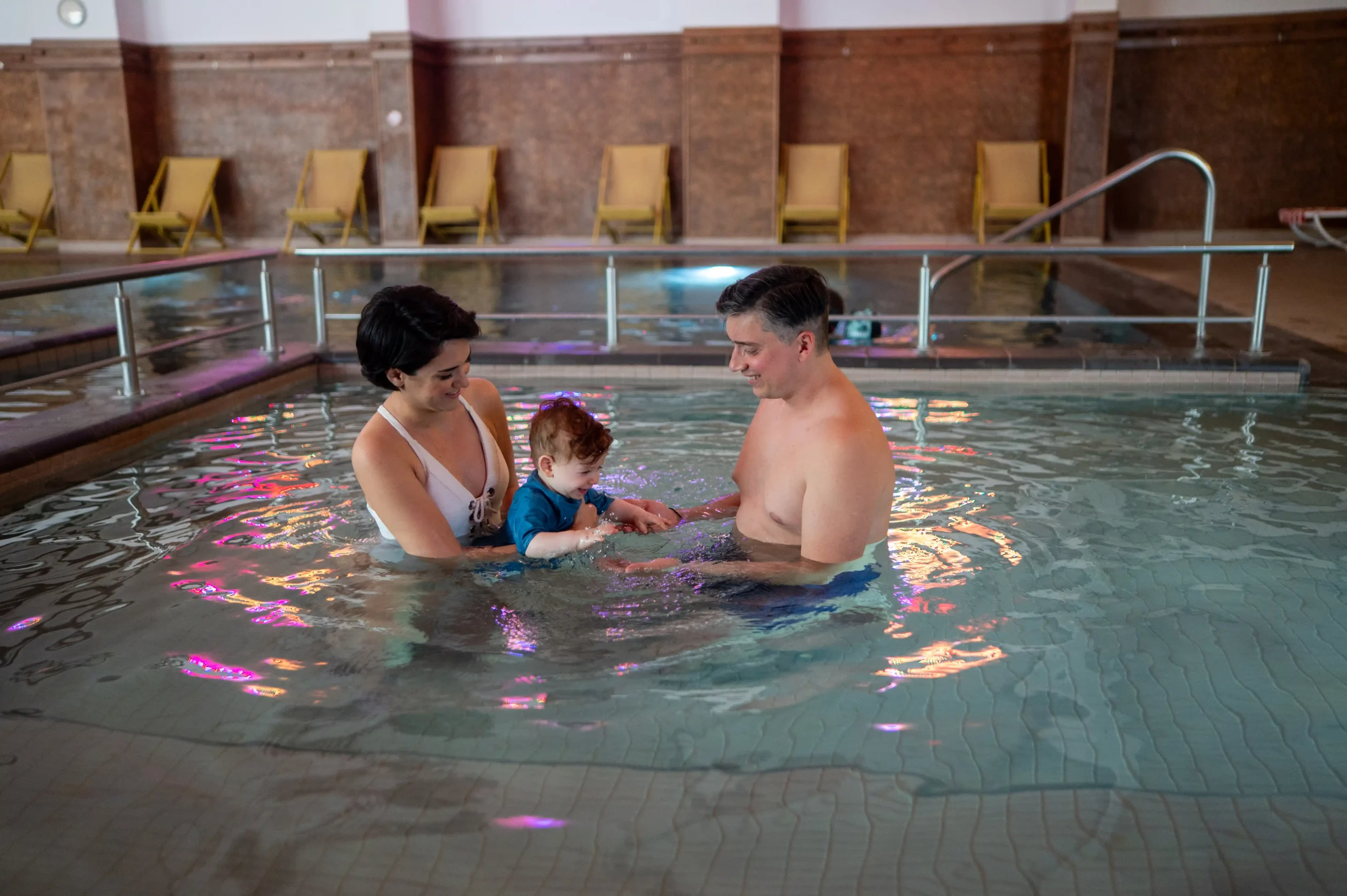 An Autumn Family Holiday in the Mountains – Ideas for All Ages - хотел Ruskovets.com Parents with a young child enjoying the indoor mineral pool at Ruskovets Resort