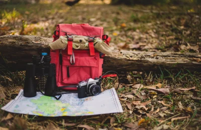 hipster-red-backpack-map-forest