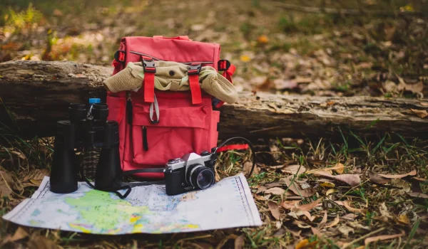 hipster-red-backpack-map-forest