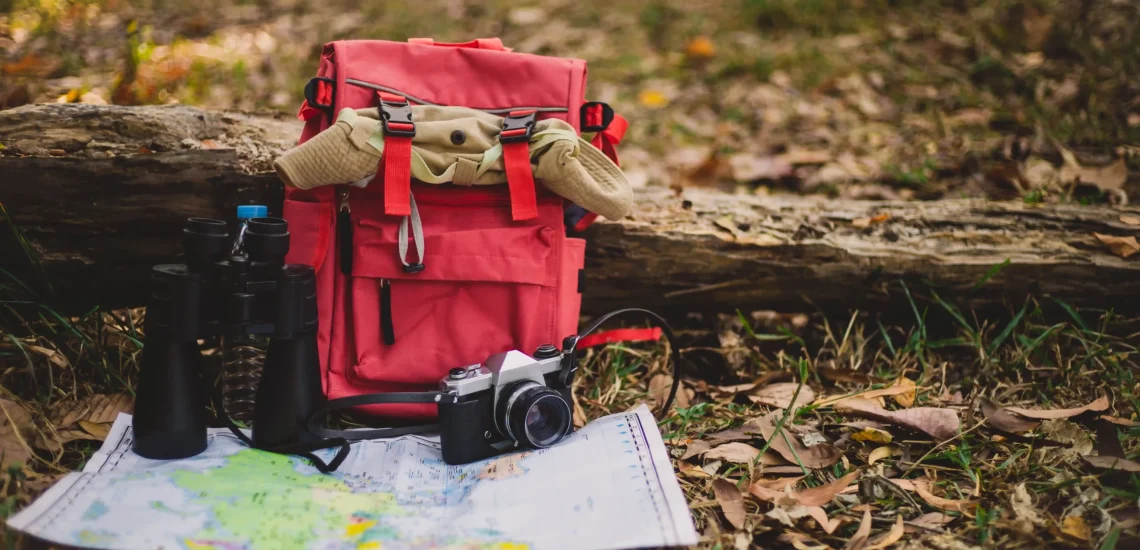 hipster-red-backpack-map-forest