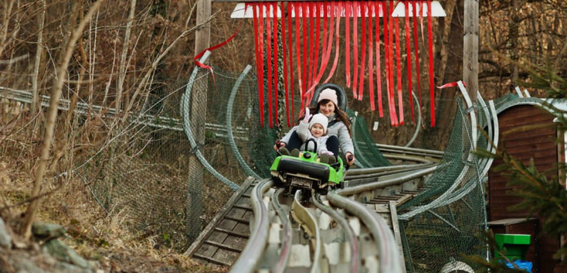 mother-with-daughter-ride-electric-sleigh-rails-1-1